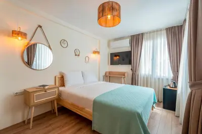 a hotel room with a bed and a mirror at Aya Butik Otel in Buyukada