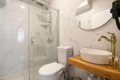 a bathroom with a toilet and a sink and a shower at Aya Butik Otel in Buyukada