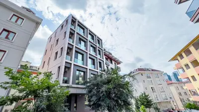 a tall white building with trees in a city at Homie Suites - Newly-constructed Apartment Complex in Beşiktaş in Istanbul