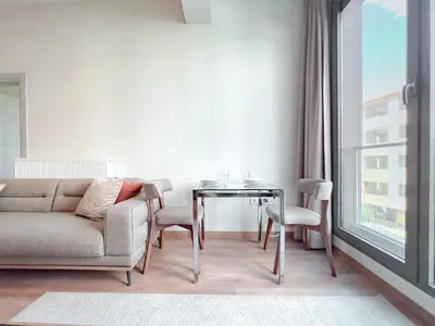 a living room with a couch and a table and a window at Homie Suites - Newly-constructed Apartment Complex in Beşiktaş in Istanbul