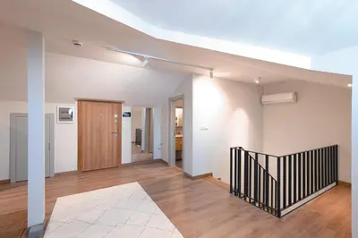 an empty living room with a staircase in a house at Homie Suites - Newly-constructed Apartment Complex in Beşiktaş in Istanbul