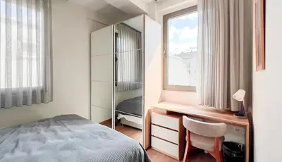 a bedroom with a desk and a bed and a window at Homie Suites - Newly-constructed Apartment Complex in Beşiktaş in Istanbul