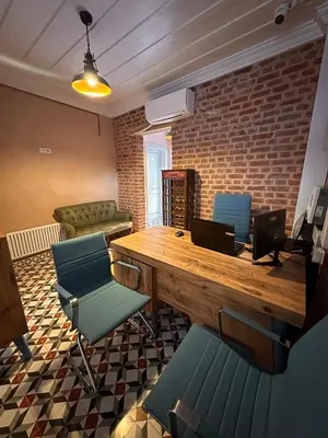 a room with a desk with two laptops and chairs at Lovely History in Istanbul
