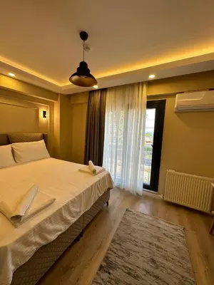 a bedroom with a large bed and a window at Lovely History in Istanbul