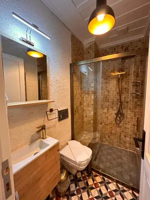 a bathroom with a sink and a shower and a toilet at Lovely History in Istanbul