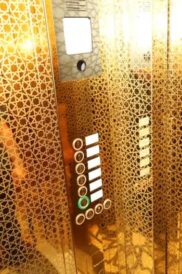 a metal elevator with a sign on the wall at Novus Hotel İstanbul in Istanbul