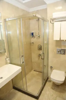 a bathroom with a shower with a toilet and a sink at Novus Hotel İstanbul in Istanbul