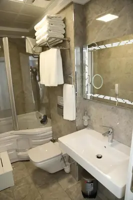 a bathroom with a sink and a toilet and a mirror at Novus Hotel İstanbul in Istanbul