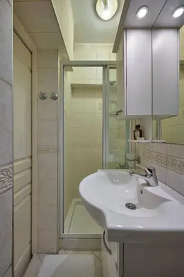 a white bathroom with a sink and a shower at Cozy Cute 1 bed1bath Bebek Private Terrace! #75 in Istanbul
