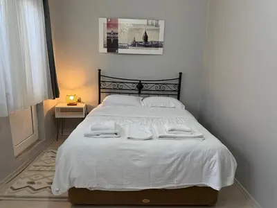 a bedroom with a white bed with towels on it at Güneş House in Istanbul