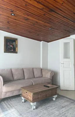 a living room with a couch and a wooden ceiling at Güneş House in Istanbul