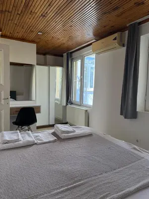 a bedroom with a large bed with a wooden ceiling at Güneş House in Istanbul