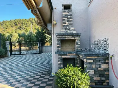 a stone fireplace on the side of a building at Doğanın Kalbindeki Eviniz-6 Kişi in Gemlik