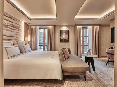 a bedroom with a large white bed and a couch at Swissotel Uludag Bursa in Bursa