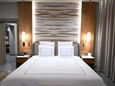 a bedroom with a large bed with white sheets and pillows at Swissotel Uludag Bursa in Bursa