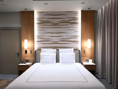 a bedroom with a large white bed with two pillows at Swissotel Uludag Bursa in Bursa