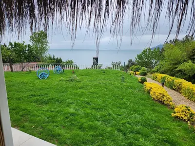 a view of a grassy yard with a view of the ocean at The Roof Ada in Adalar