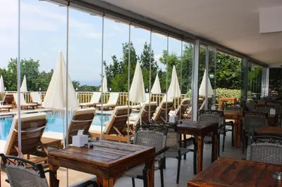 a restaurant with tables and chairs and a pool at The Roof Ada in Adalar