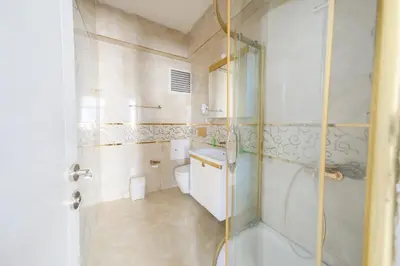 a bathroom with a toilet and a glass shower at Halil Bey Konağı in Istanbul