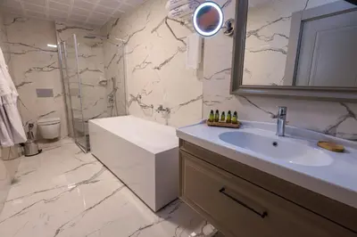 a bathroom with a sink and a toilet and a shower at Brand Business Hotel in Corlu