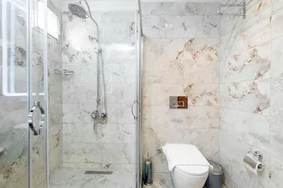 a bathroom with a shower and a toilet at Brown Mansion Oldcity in Istanbul