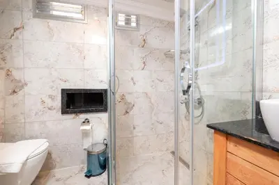 a bathroom with a shower and a toilet and a sink at Brown Mansion Oldcity in Istanbul