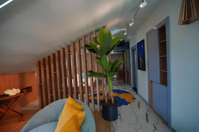 a living room with a blue couch and a potted plant at Vanilla 11 in Istanbul