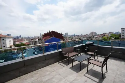 a balcony with chairs and a table on a roof at Vanilla 11 in Istanbul