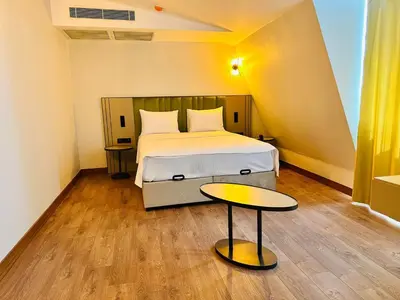 a bedroom with a bed and a table at Nice Royal Cıty in Istanbul