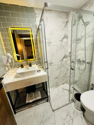 a bathroom with a sink and a shower at Nice Royal Cıty in Istanbul