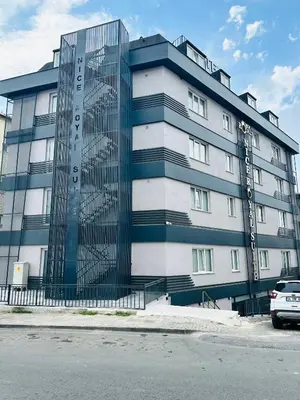 a blue and white building with a car parked in front at Nice Royal Cıty in Istanbul