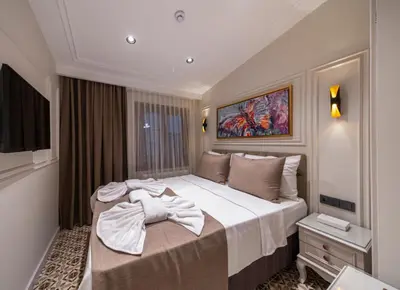a hotel room with a large bed with towels on it at Pera Luna Premium Hotel in Istanbul