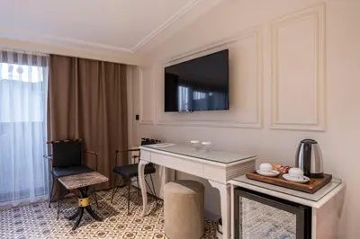 a hotel room with a desk and a tv on the wall at Pera Luna Premium Hotel in Istanbul