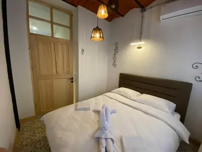 a bedroom with a bed with a stuffed animal on it at Balat Historical House in Istanbul