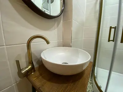 a bathroom with a white sink and a mirror at Balat Historical House in Istanbul