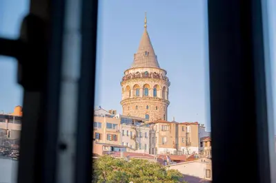a tall building with a tower on top of buildings at Galata Greenland Hotel in Istanbul