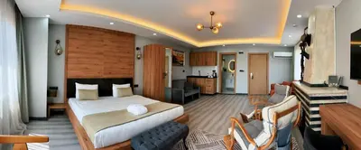 a hotel room with a bed and a kitchen at Galata Greenland Hotel in Istanbul