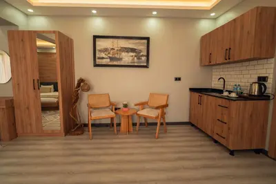 a room with a kitchen with two chairs and a table at Galata Greenland Hotel in Istanbul
