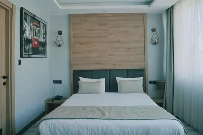 a bedroom with a large bed with white pillows at Galata Greenland Hotel in Istanbul