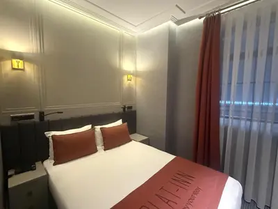 a bedroom with a bed with two pillows and a window at Union Hotel Plat Inn -Special Category in Istanbul