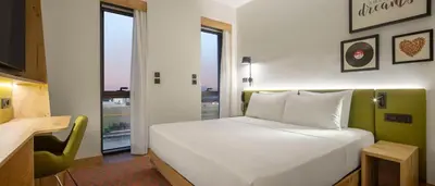 a bedroom with a large white bed and a window at Hampton By Hilton Cerkezkoy in Tekirdag
