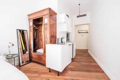 a kitchen with white cabinets and a sink in a room at Homie Suites - Historical Apartment Nearby Galata Tower in Istanbul