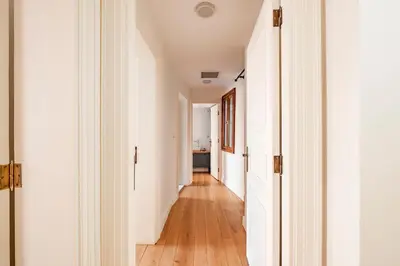 a hallway with white walls and wooden floors at Homie Suites - Historical Apartment Nearby Galata Tower in Istanbul