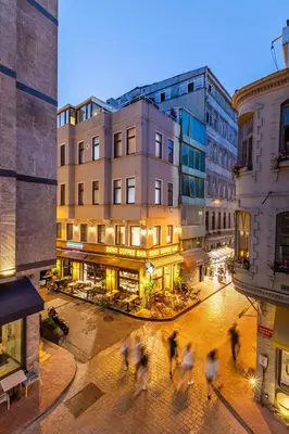 a group of people crossing a street in a city at Bdino Boutique Hotel in Istanbul