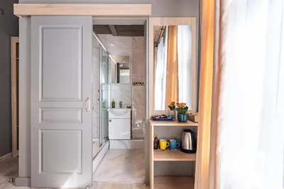 a bathroom with a shower and a white door at Bdino Boutique Hotel in Istanbul