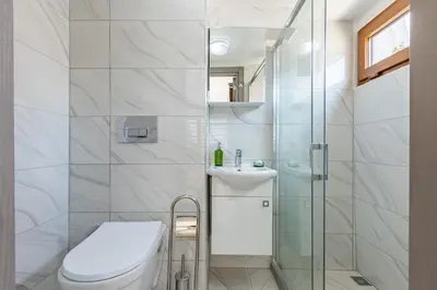 a bathroom with a toilet and a glass shower at Bdino Boutique Hotel in Istanbul