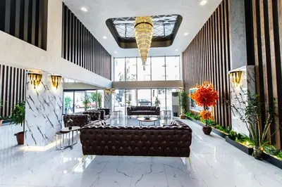 a lobby with a leather couch and a table at Blue Vista Houses & Spa in Esenyurt