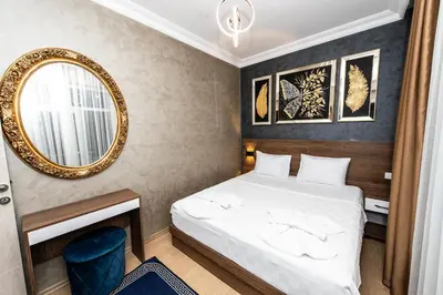 a hotel room with a bed and a mirror at Blue Vista Houses & Spa in Esenyurt