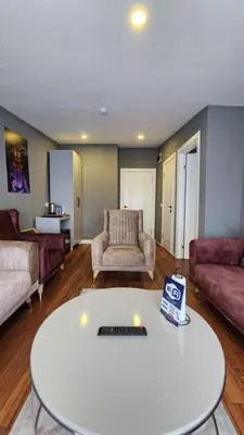 a living room with a white table and a couch at TAKSİM GOKOTTA SUiTE in Istanbul