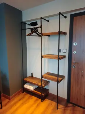 a black book shelf with wooden shelves in a room at Karaköy in Karaköy Hotel in Istanbul